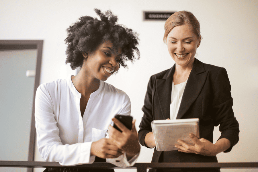 two office workers reviewing written documents